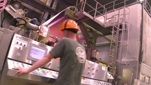Paper machine and operator at the control panel. Paper production Stockbeeldmateriaal 271058176