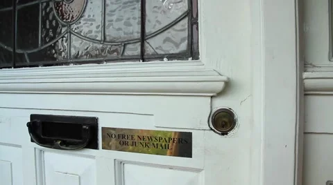 Paper mail being delivered through a door mounted mailbox opening. Stock-Footage 68079666