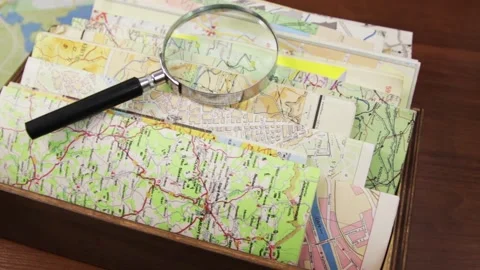 Paper maps of different countries and the magnifying Stock Footage 131179223