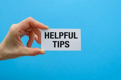 Paper note with phrase Helpful Tips on blue background, top view. Stock Photos