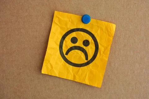 Paper note with sad face Stock Photos