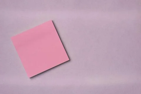 Paper note sticker on a pink background. Space for text. Flat lay, top view. Stock Photos