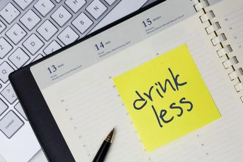 Paper note with the words - Drink less - in business desk. How to get bette.. Stock Photos