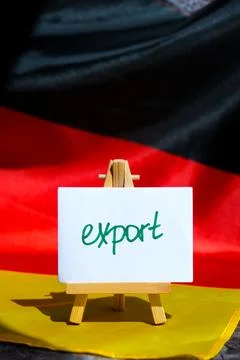Paper note with words EXPORT on National symbol of Germany. German wave silky Foto stock