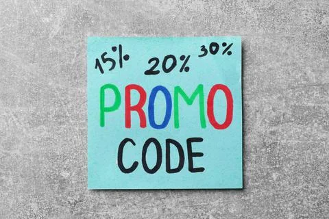 Paper note with words Promo Code on light grey table Stock Photos