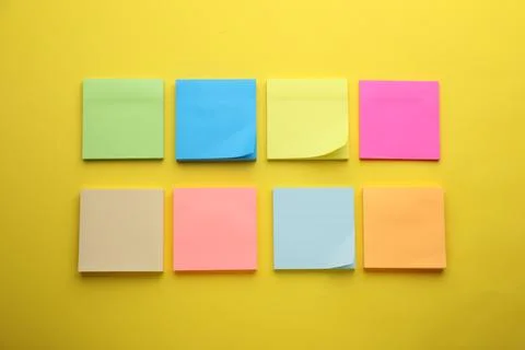 Paper notes on yellow background, flat lay Stock Photos