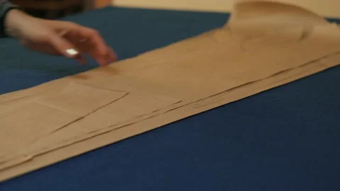 Paper pattern on the table. The dressmaker's work process. Video stock 152103869
