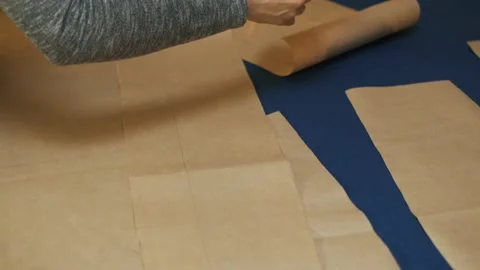 Paper pattern on the table. The dressmaker's work process. Stock Footage 152103921