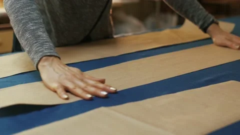 Paper pattern on the table. The dressmaker's work process. Video stock 152103996