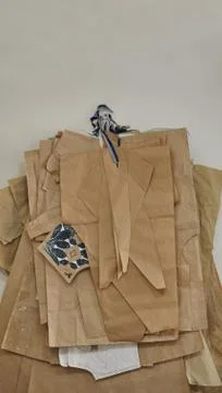 Paper patterns for sewing different sizes hang on the wall in a sewing factor Stock Photos