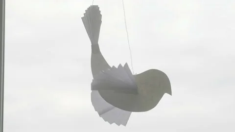 Paper pigeon is hanging on string. Child made symbol of peace in quarantine. Stock Footage 132166437