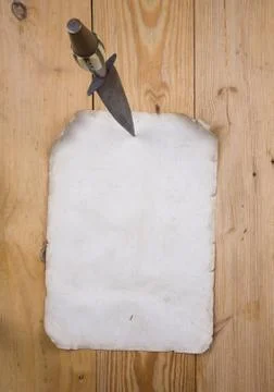 Paper pinned with a dagger Stock Photos