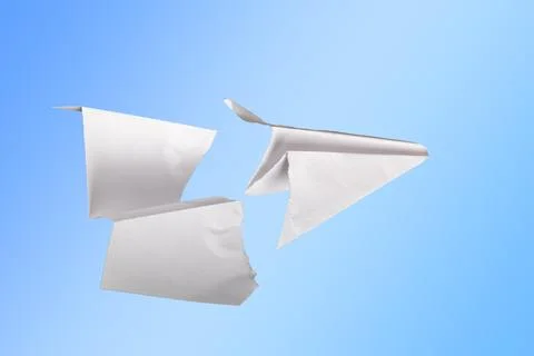 Paper plane in the middle it is torn. concept of breakdown, accident, crash.. Stock Photos