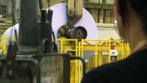 Paper production. The crane operator controls the crane and moves the roll o Video stock 125756410