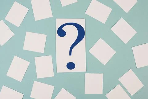 Paper with a question mark in the middle, small  empty stickers around, copy Stock Photos