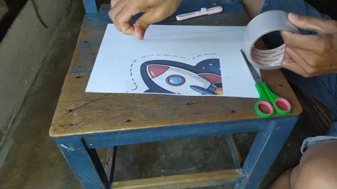 Paper Rocket Illustration Cutout Craft Process on Wooden School Chair Top View Stock Footage 343637840