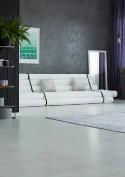 Paper settee in apartment interior Stock Photos
