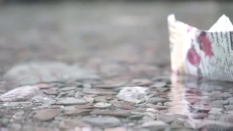 Paper ship on a background of beautiful clean water, macro video, design  elemen Stock Footage 78233568
