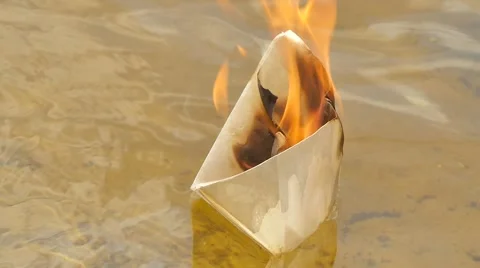 Paper Ship in Flame on the Watery Surface Dreams Did Not Come True Lost Hope Stock Footage 64774355