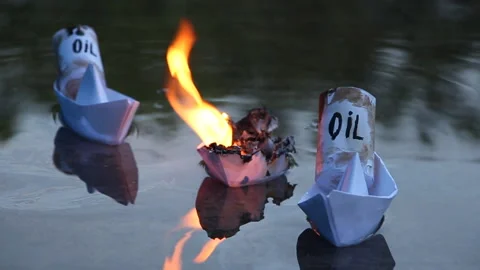 A paper ship with oil barrels explodes from their leakage Stock Footage 108978829