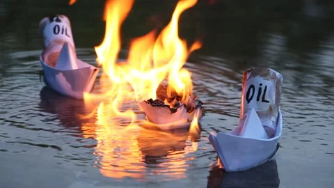 A paper ship with oil barrels explodes from their leakage Stock Footage 109006868