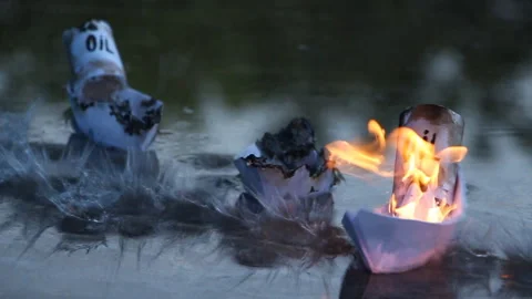 A paper ship with oil barrels explodes from their leakage Stock Footage 109102877