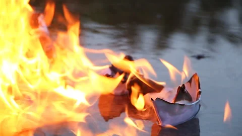 A paper ship with oil barrels explodes from their leakage Stock Footage 109105376