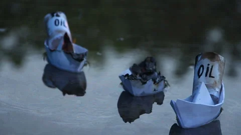 A paper ship with oil barrels explodes from their leakage Stock Footage 109118284