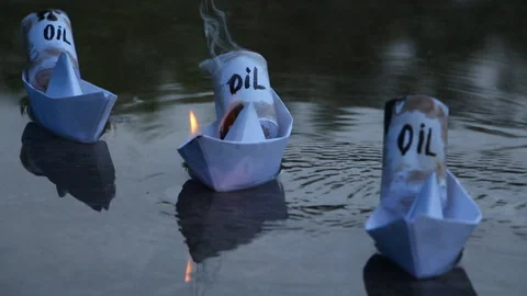 Paper ships with oil barrels explode from their leakage Stock Footage 108630836