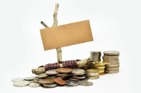 Paper sign board with stack of coins 스톡 사진