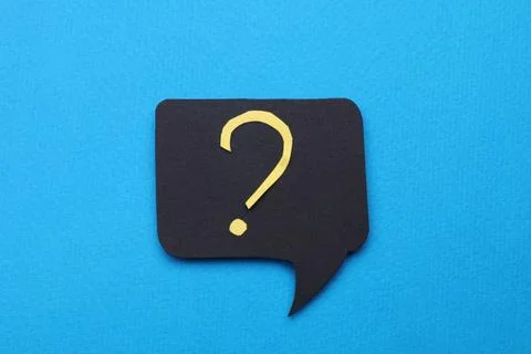 Paper speech bubble with question mark on light blue background, top view Stock Photos