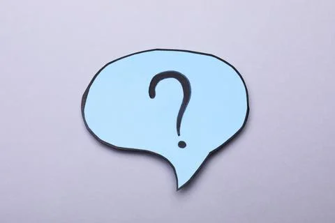 Paper speech bubble with question mark on light grey background, top view Stock Photos