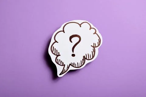 Paper speech bubble with question mark on violet background, close-up Stock Photos