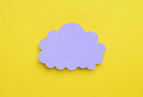 Paper speech bubble in shape of cloud on yellow background, top view. Space.. Stock Photos