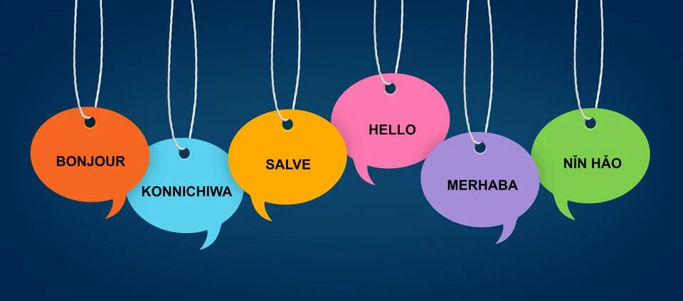 Paper speech bubbles with greetings in different languages hanging on dark .. Stock Photos