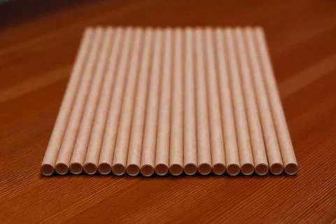 Paper straw on wood background table Stock Photos