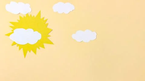 The paper sun and clouds move across the paper sky. DIY. Stock Photos