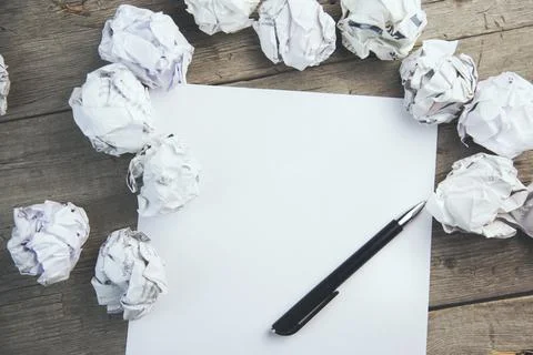 Paper surrounded with crumpled papers Stock Photos