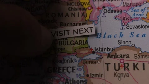 Paper tag reading Visit Next on a map of Europe and Bulgaria for travel conce Stock Footage 346504316