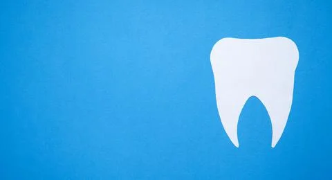 Paper Tooth on blue background. Stock Photos