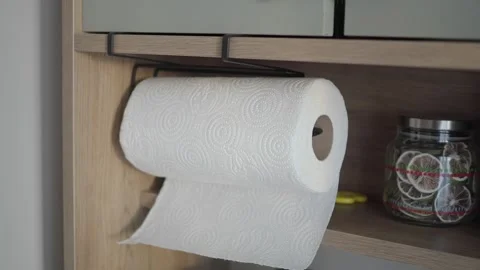 Paper towel roll is mounted in a kitchen cabinet area Stock Footage 333031207