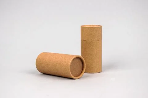 Paper tubes on grey background with copyspace - cardboard packaging for natur Foto stock