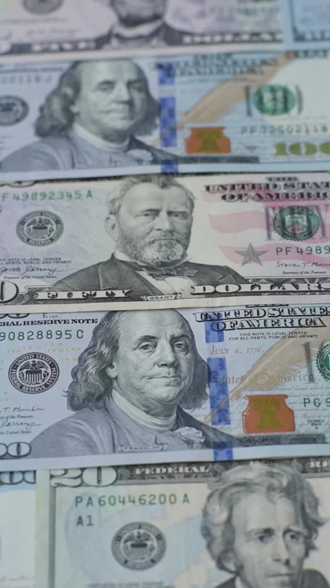 Paper US dollar bills of various denominations and cent coins as a business tool Stock Footage 338011869