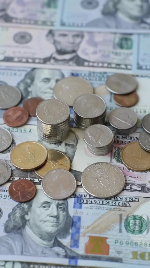 Paper US dollar bills of various denominations and cent coins as a business tool Stock Footage 338011875