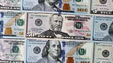 Paper US dollar bills of various denominations and cent coins as a business tool Stock Footage 338011947