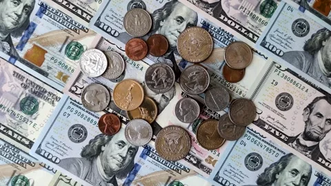 Paper US dollar bills of various denominations and cent coins as a business tool Stock Footage 338011986