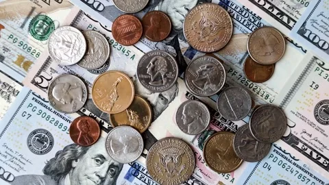 Paper US dollar bills of various denominations and cent coins as a business tool Stock Footage 338011994
