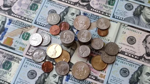 Paper US dollar bills of various denominations and cent coins as a business tool Stock Footage 338011999