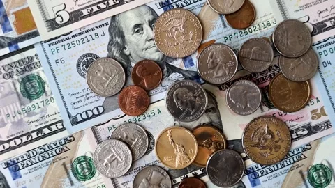 Paper US dollar bills of various denominations and cent coins as a business tool Stock Footage 338012001