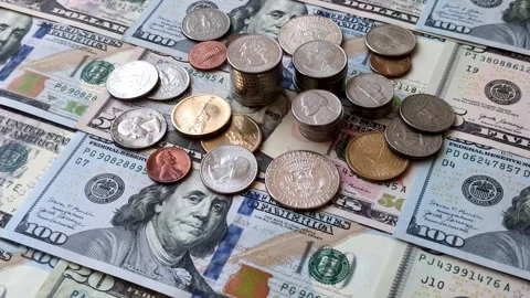 Paper US dollar bills of various denominations and cent coins as a business tool Stock Footage 338012003